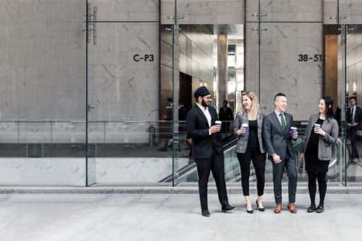 Business people with coffee laughing