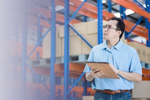 Man in warehouse using tablet