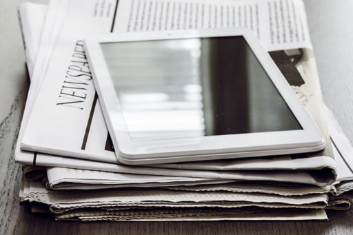 Tablet and newspaper